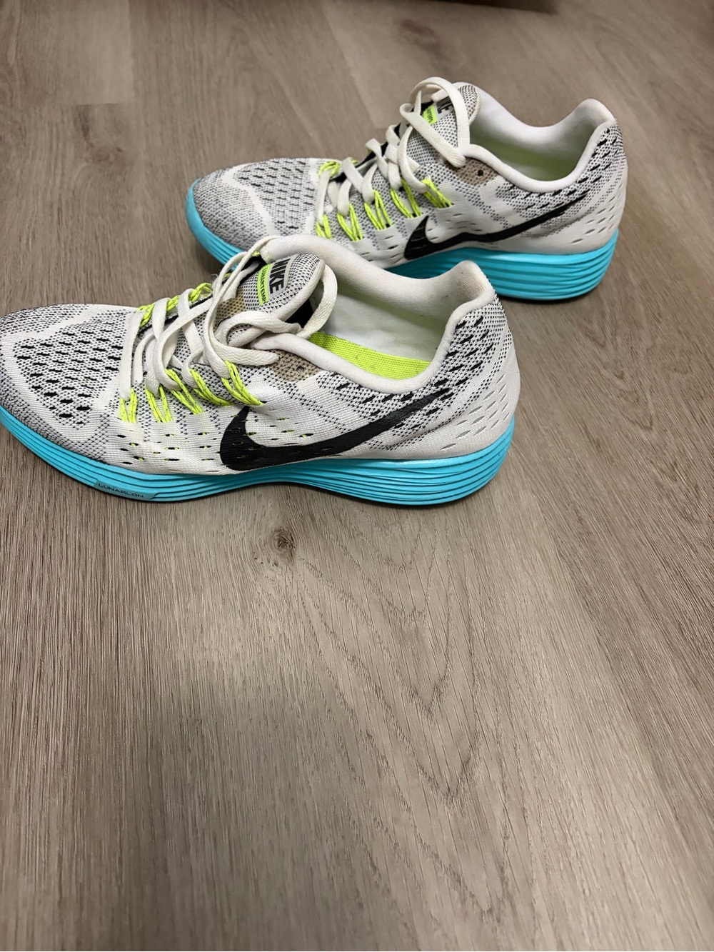 Nike White Running Shoes with Blue Soles and Neon Yellow Details